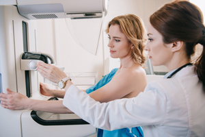 Female patient is being receiving a 3-D mammogram from a female provider